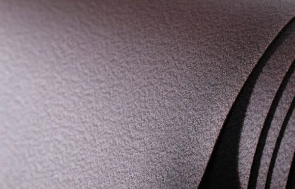 Close-up on the texture of Nisiar N-07 grape marc leather, light dappled brown