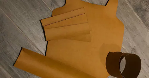 Pieces of unwashed caramel Kraft-Tex on a grey floor.