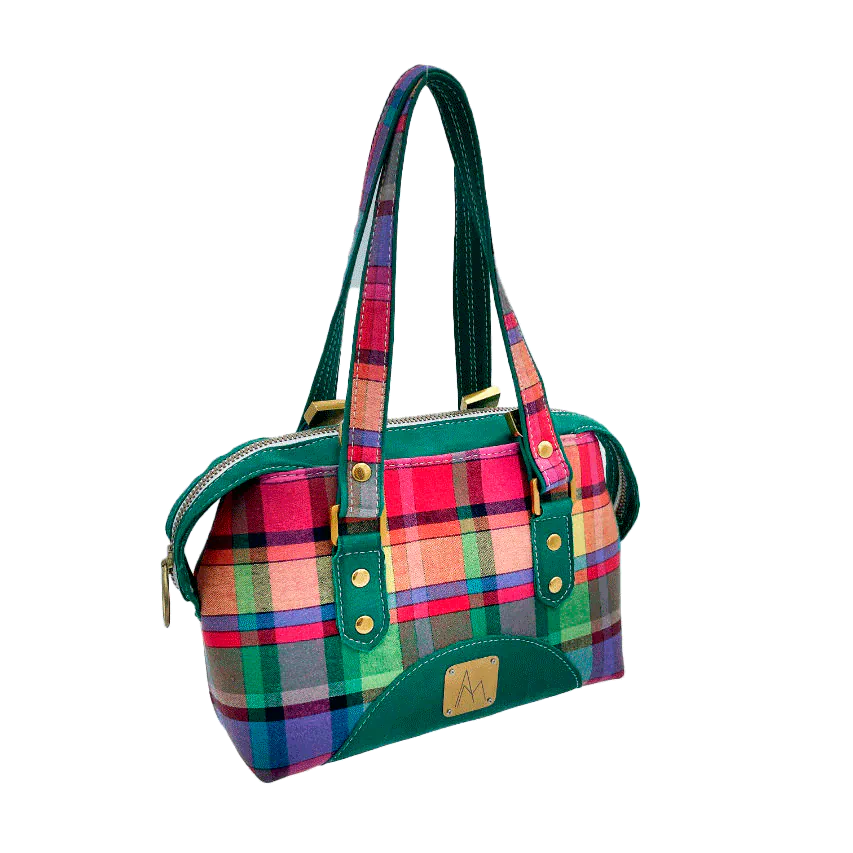 A wallet bag made of forest green leather and multicolored madras fabric.