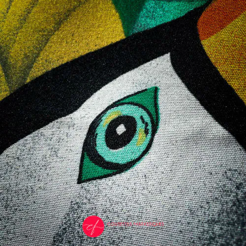 A backpack made of satin black leather, a parrot-patterned neck scarf, and black wool fabric.