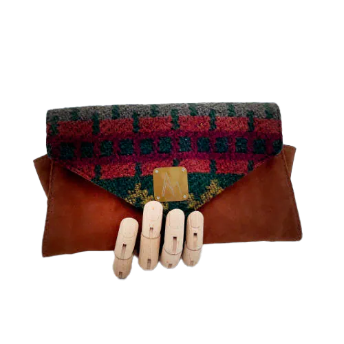 A wallet made from chestnut faux suede and geometric-patterned wool fabric, with a viscose lining featuring a geometric print.