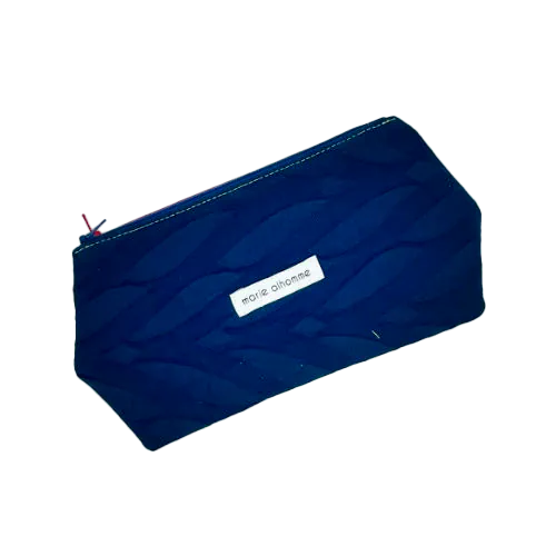 A double zippered pouch sewn from several babywearing wrap scraps (blue and red) and white faux leather.