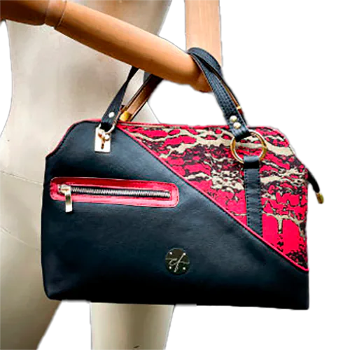 A handbag made of black, gold, and red faux leather and wrap fabric in the same tones, with a marbled pattern.