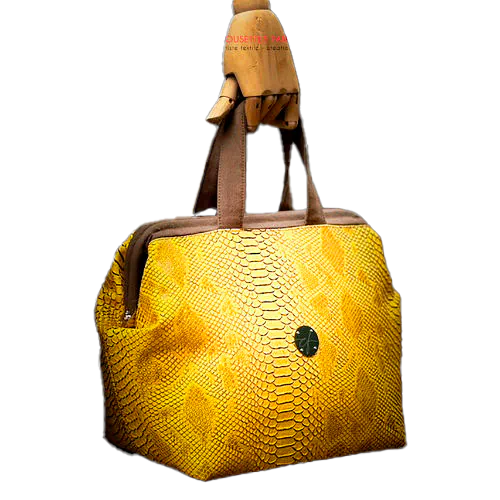 A handbag made with crocodile-textured yellow and brown synthetic leather.