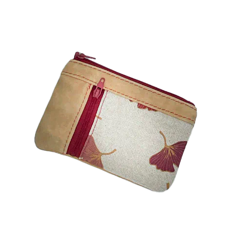 A mini zippered coin purse made of camel colored leather and a red Ginkgo Biloba leaves patterned polycotton canvas.