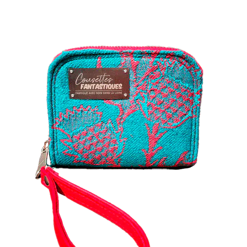 A small zippered card and coin holder made from blood-red and emerald green wrap fabric with thistle patterns and emerald green linen. It comes with a bright red faux leather wrist strap.