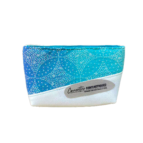 A small zippered pouch made of blue and white babywearing wrap with pointillist star motif and white faux leather.