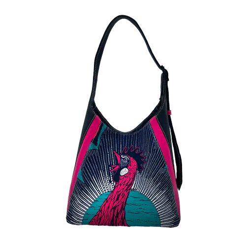 A shoulder bag made from a wax-style fabric and scraps of black and pink leather, lined with turquoise fabric.