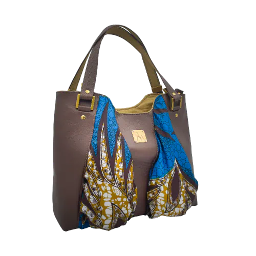 A shoulder bag made of brown goat leather, blue and mustard wax fabric, and mustard-yellow lining.