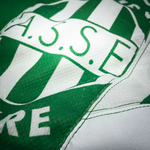 A shoulder bag in white and green leathers combined with a vintage green-and-white football jersey, and a white-and-green polyester satin lining.