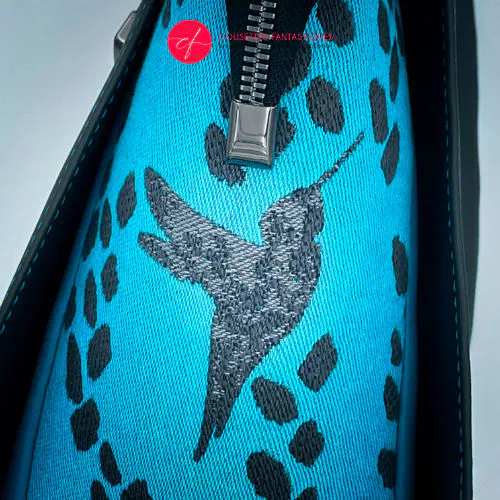 A shoulder bag made of turquoise babywearing fabric with hummingbird and petal motifs, combined with gray and turquoise imitation leather.
