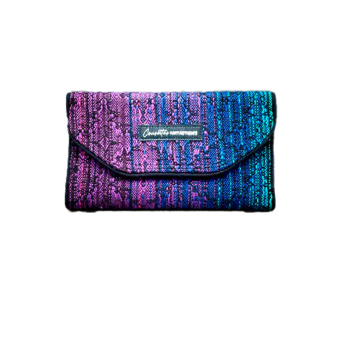A wallet made from a gradient blue to violet babywearing wrap on the outside and purple voile on the inside.
