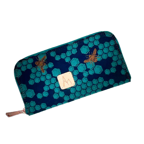 A zippered card and coin holder made with dark blue and petrol blue honeycomb patterned babywearing wrap fabric with bees.