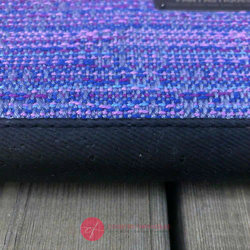 A cardholder and zippered coin purse made from a gradient mirror wrap from pink to blue and black cork.