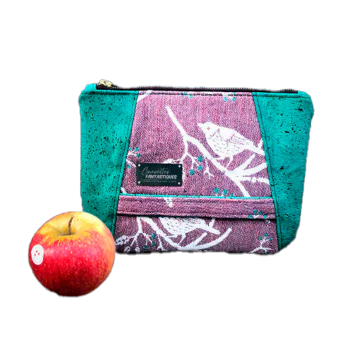 Une pochette zippée cousue dans une écharpe de portage mauve et verte au motif d'oiseaux sur des branches, associée à du liège vert émeraude.